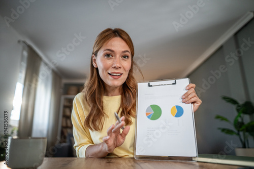 Tableau sur toile Woman presenting data charts during virtual business meeting