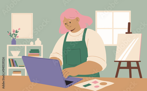 A smiling artist works on a digital portfolio on a laptop in a cozy studio.  Bright, modern, and inviting.