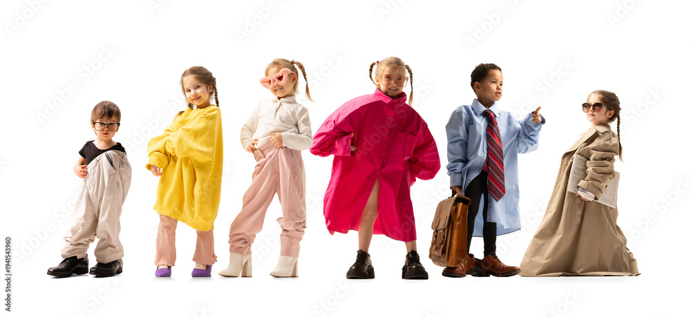 Fototapeta premium Kids wearing oversized adult clothes posing like professionals, symbolizing childhood imagination and future careers. Ideal for advertising, education campaigns, parenting content and branding visuals