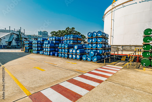 Blue barrel In the warehouse, 200-liter chemical barrels are arranged on wooden pallets and waiting for delivery. Transportation technology, the petroleum industry