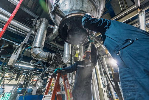 Male worker inspection weld tank, penetrant tank chemical grease