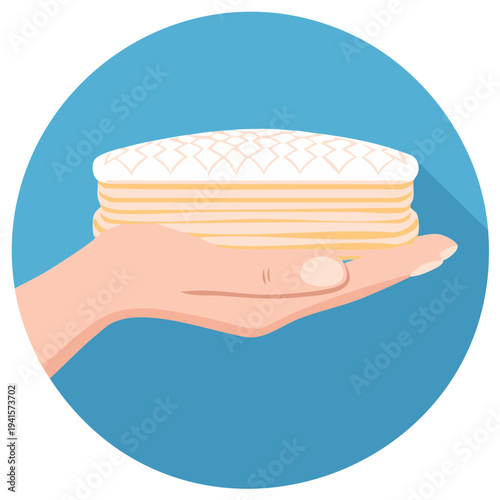 Hand holding a layered cushion or mattress topper against a blue circular background with long shadow