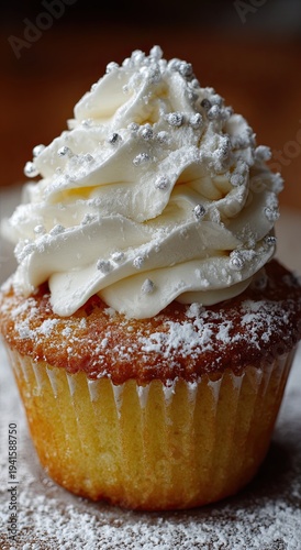 Vanilla cupcake with powdered sugar and vanilla icing