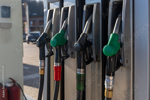 Fuel Pump Nozzles at Gas Station. Close-up of multiple fuel pump nozzles at a gas station, showing gasoline and diesel refueling equipment, energy supply, and transportation service.