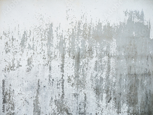 фотографія Grungy weathered concrete wall with dark water stains and mold texture, industri