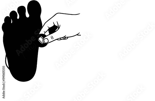 A hand holds a small object to the sole of a dark foot