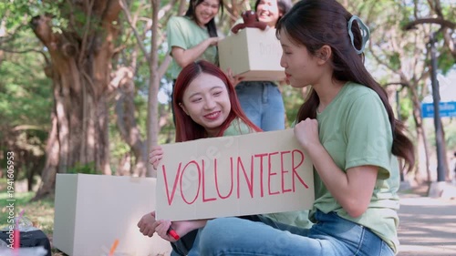 Community Commitment: A group of volunteers works together, a moment of compassion and solidarity with the volunteer sign. A symbol of their shared dedication.