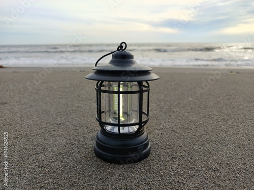 Lantern on beach during sunset Ramadan Kareem concept