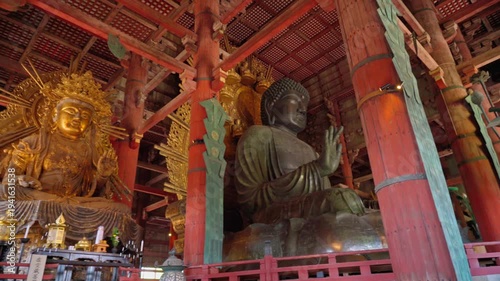 Nara, Japan - Sep 26 2024, Panoramic view of the Sitting Buddha Vairochana, a fifteen-meter bronze statue of Buddha, and a side-standing gilded statue of Buddha, at Todaiji Temple, Nara, Japan