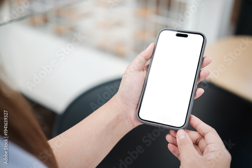 Person holding a smartphone with empty screen for copy space, ideal for displaying mobile app design, website interface, or online service concept.