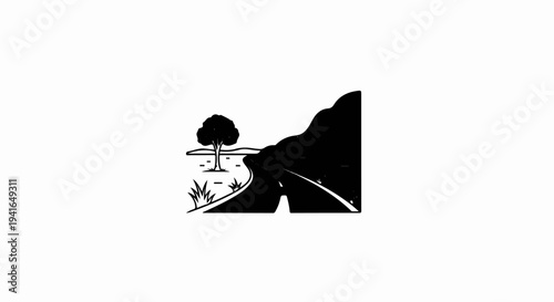 A winding road leads past a solitary tree toward a mountain