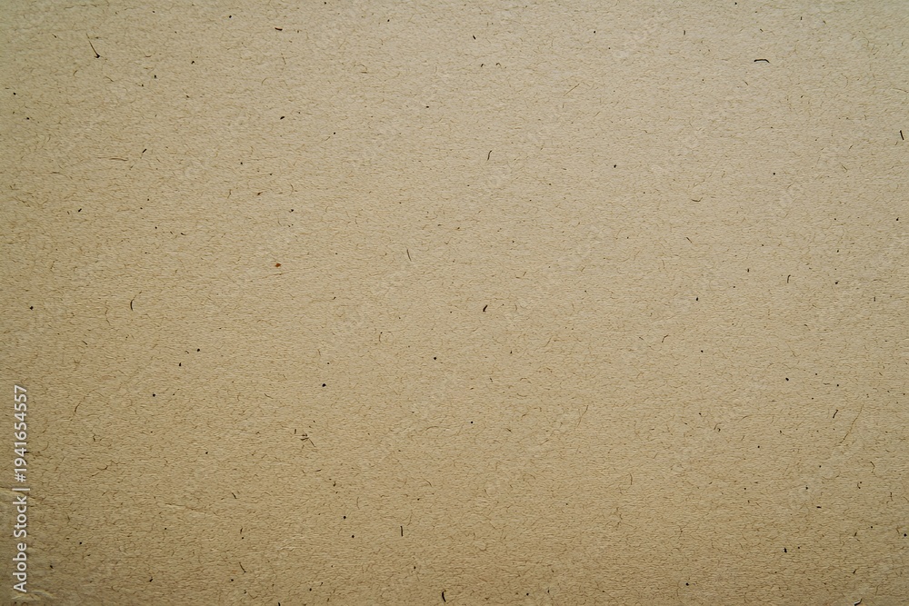 Obraz premium Beige cardboard surface texture with visible fibers and speckles
