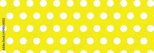 Large size hand drawn white color cute seamless polka dots patterns on a light yellow background. Vintage polka dots used in graphic design, pop art, home decoration and textile product.