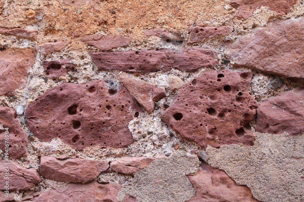 Fototapeta premium Red Natural Stone Wall Texture – Rustic Architecture Background