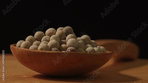 white peppercorns in the wooden spoon