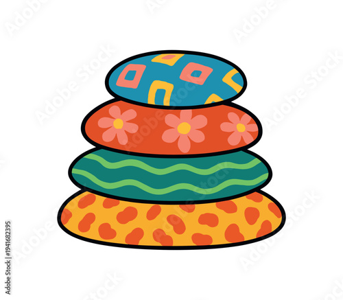 Four stacked round cushions in bright colors and bold patterns — top geometric, second floral, third wavy stripes, bottom spotted — shown as a playful decorative element for home or children’s design.
