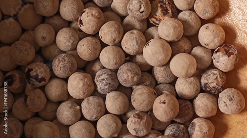 white peppercorns in the wooden spoon