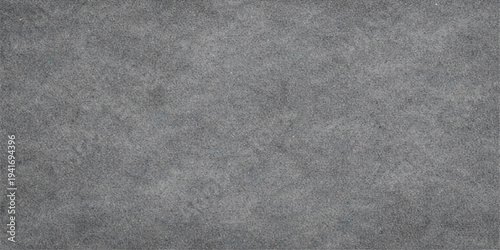 A dark grunge backdrop featuring a blend of black leather and fabric textures alongside a rough gray textile material for a blank textured wallpaper design