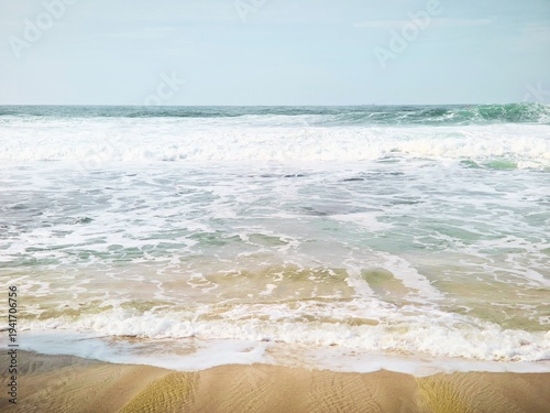 Tropical Beach Shoreline with Soft White Sea Foam and Sand