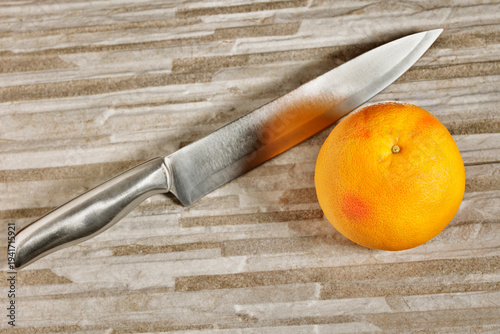 Fresh  grapefruit and kitchen knife
