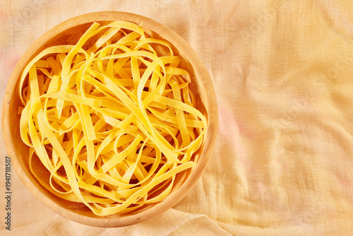 Plate  with uncooked  tagliatelle pasta
