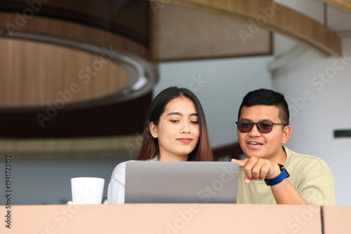 Asian Young Couple Colleague Working Together at Cafe Restaurant.