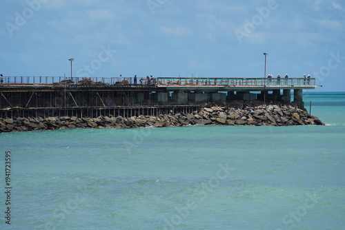 Construction work on a new pier on Iracema beach, with numerous vendor stalls and other amenities for beachgoers. Fortaleza - Ceará, Brazil.