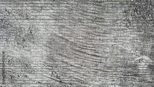 Photography Close up grooved concrete pavement surface texture with linear pattern and rough weathered urban background
