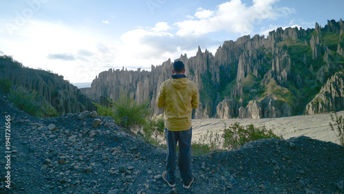 Man in Yellow Jacket Overlooking the Spiky Rock Formations of Valle de las Animas, La Paz, Bolivia