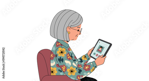 An elderly woman with grey hair and glasses sits in a red armchair, holding a tablet displaying a video call.