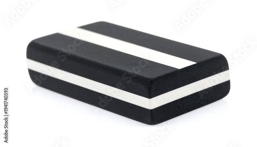 Rectangular eraser is black with two horizontal white stripes, isolated on a white background with soft shadows