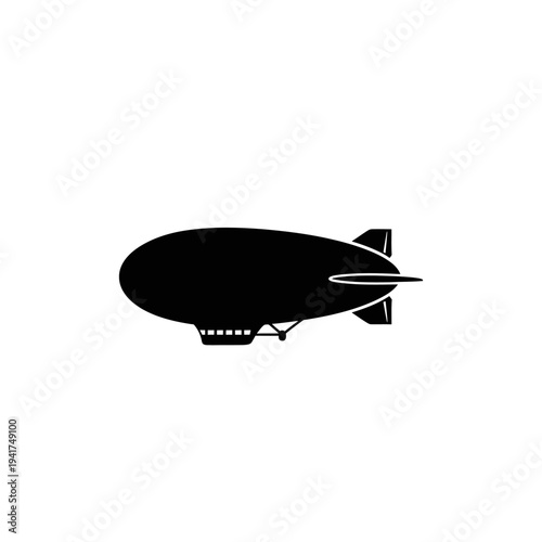 Silhouette of a blimp aircraft in flight.