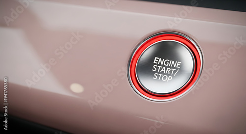 Close-up of a shiny engine start-stop button in a vehicle.