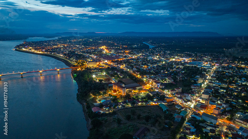 Pakse City and Its Iconic Bridge Over the Mighty Mekong. In the cool mornings and calm evenings, locals gather along Pakse Bridge to exercise, relax, and watch the sun rise and set over the Mekong.