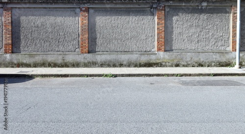 Wallpaper Mural Grunge rough concrete wall with rough brick columns.  Tiled sidewalk and street in front. Urban background for copy space. Torontodigital.ca