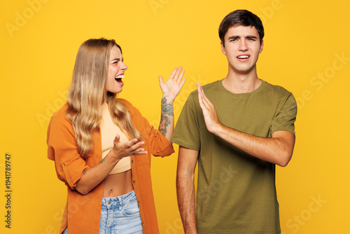 Εκτύπωση καμβά Young angry sad tired couple two friends family man woman they wear shirt casual clothes together scream shout cry isolated on pastel plain light yellow background studio portrait