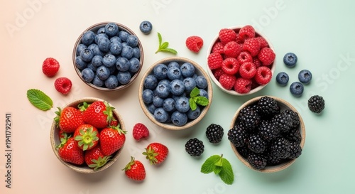 Fresh berries assortment in bowls overhead view colorful food composition