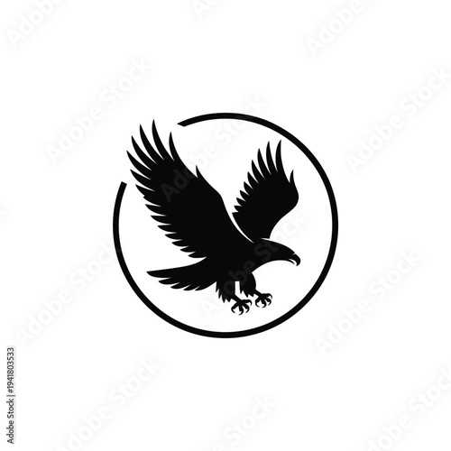 A striking black silhouette of an eagle with wings spread within a circle
