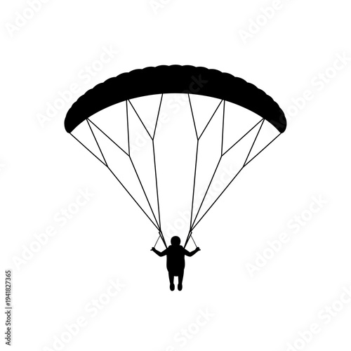 Silhouette of a paraglider in flight.