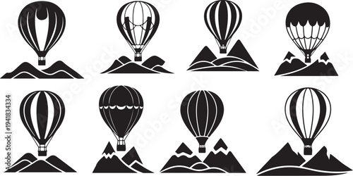 Hot air balloons flying over mountains in black silhouette