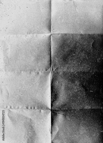 Heavy creased and folded recycled paper. Black grunge background texture