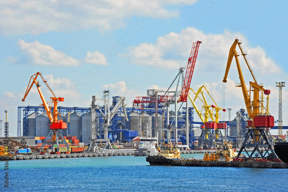Fototapeta premium Tugboat and port cargo crane