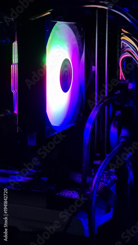 Colorful RGB liquid CPU cooler fan glowing inside modern gaming desktop computer case with neon lighting