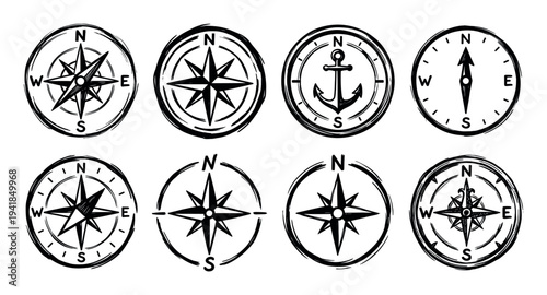 Set of eight hand-drawn compass rose icons in a black grunge sketch style for navigation, travel, and nautical adventure themes, showing various designs and directions