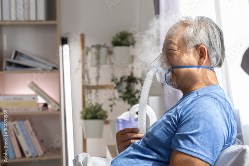 Obraz na płótnie Elderly senior Asian man wearing oxygen breathing mask indoors room feeling tire
