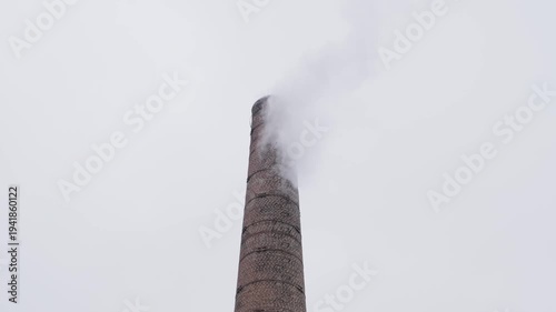 smoke streams from brick chimney on cloudy day, slow motion
