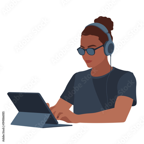 A woman wearing headphones and using a tablet in a modern workspace