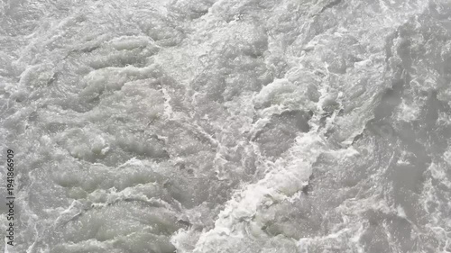 rapid flow of water in river, top view, slow motion
