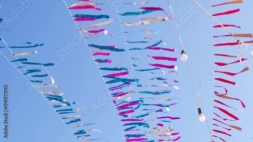 shiny rustling flags in the wind hung for the Ramadan holiday in Egypt, slow motion
