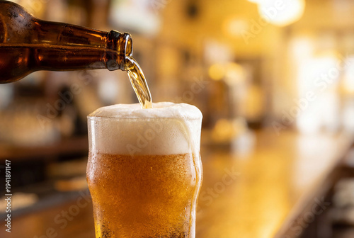 Wallpaper Mural Beer pouring from bottle into glass with overflowing foam on bar counter Torontodigital.ca